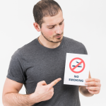 652e6e0e50acfc9c6d430363_young-man-pointing-her-finger-toward-no-smoking-sign-isolated-white-backdrop.png